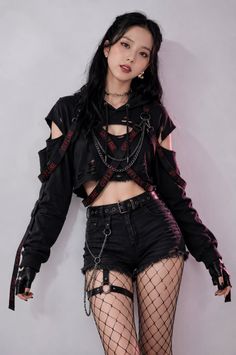 Woman in a gothic-style outfit with a cropped hoodie and fishnet stockings