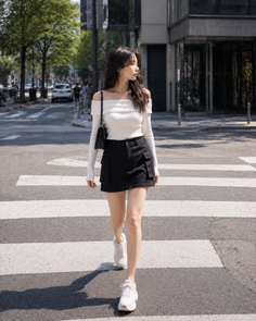 Woman in an off-shoulder top and mini skirt crossing a street