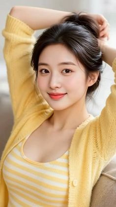 Woman in a yellow cardigan and striped top with her hair in an updo