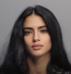 Woman with long black hair in a portrait shot with soft lighting