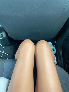 Person's legs in a car interior, viewed from above