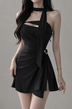 Woman in a black cutout mini dress with long dark hair