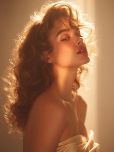 Woman with long wavy hair bathed in golden hour light