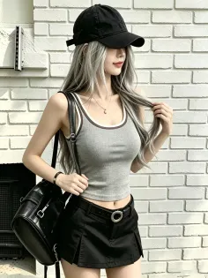 Woman with long gray hair wearing a black cap, crop top, and mini skirt