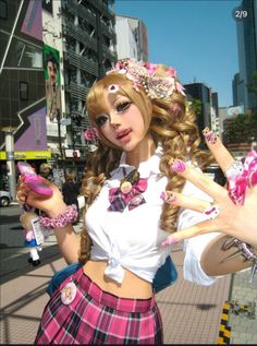 Woman in gyaru fashion with heavy makeup and a plaid skirt in a city setting