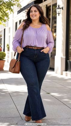 Woman with long hair wearing an off-shoulder top and flared jeans outdoors