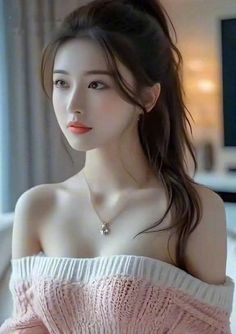 Woman in an off-shoulder sweater with a ponytail and necklace