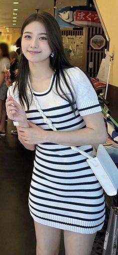 Woman in a striped dress smiling outdoors