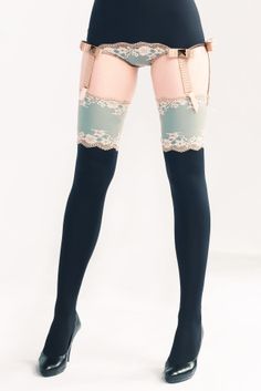 Woman wearing lingerie, garter belt, stockings, and high heels