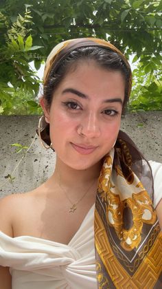 Woman wearing a head scarf and off-shoulder top outdoors