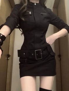 Woman in a black dress with a wide belt and thigh high boots