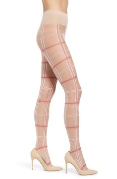 Woman wearing plaid tights and high heels on a white background