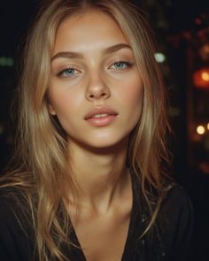 Woman with blonde hair and blue eyes in a close-up portrait