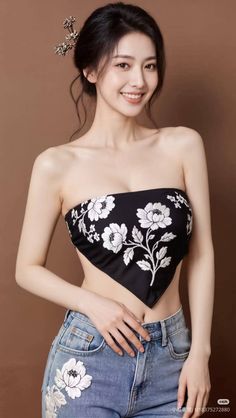 Woman with black hair and a strapless top with floral embroidery