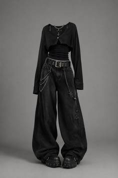 Gothic style black outfit with baggy jeans and platform shoes