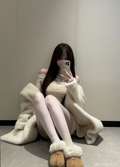 Woman with long hair taking a selfie while sitting on the floor