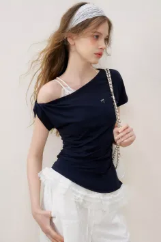 Woman with long hair wearing an off-shoulder top and white shorts