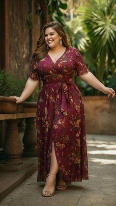 Woman in a floral maxi dress smiling outdoors