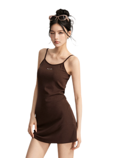 Woman in a brown dress with sunglasses on her head, winking at the camera