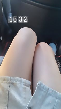 Person's legs and skirt with a digital clock overlay