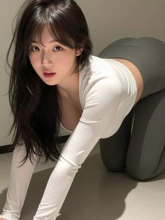 Woman in a white top and yoga pants in a provocative pose