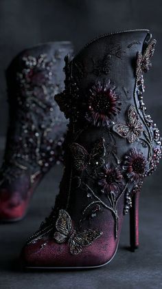 Pair of dark high heels with intricate butterfly and flower embroidery