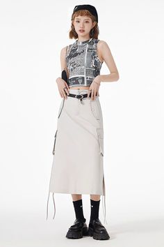 Woman in a graphic crop top and cargo skirt with a beret and chunky shoes