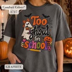 Person wearing a dark gray graphic tee with a Halloween-themed 'Too Ghoul for School' design
