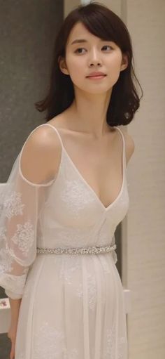 Woman in a white dress with lace details and a sparkling belt
