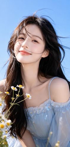 Woman with long dark hair in a blue off-shoulder dress with daisy flowers