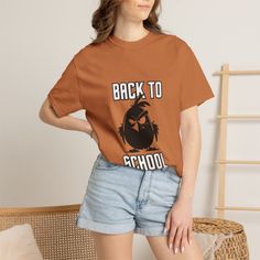 Woman in a brown t-shirt with 'Back to School' text and denim shorts