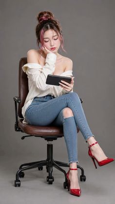 Woman in an off-shoulder shirt, ripped jeans, and red high heels sitting on a chair