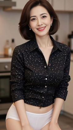 Woman in a black shirt and white underwear smiling indoors
