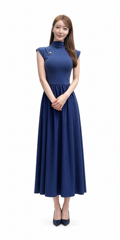 Woman in a blue dress and high heels standing against a white background