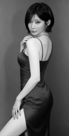 Woman in a black dress with a high slit and short hair posing provocatively