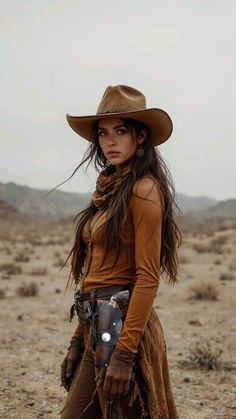 Woman in a cowboy hat and brown clothing in a desert landscape