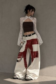 Woman in a lace top and wide leg pants with exposed midriff