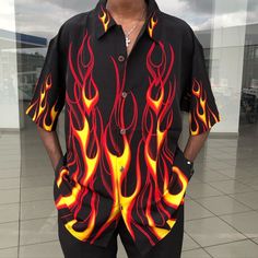 Person wearing a black short-sleeve shirt with red and yellow flame patterns