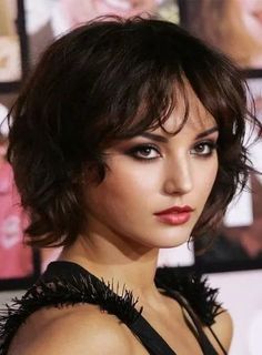 Woman with short dark hair and red lipstick wearing a black top