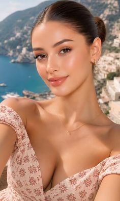 Woman in an off-shoulder dress with a cityscape and ocean in the background