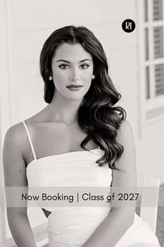 Woman with long wavy hair wearing a white dress and pearl earrings