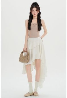 Woman with long hair wearing a strapless top and asymmetrical ruffle skirt