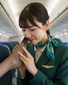 Flight attendant in uniform holding a foot in stockings to her face