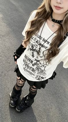 Person in a graphic t-shirt, black skirt, and fishnet stockings outdoors