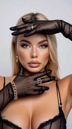 Blonde woman in black sheer gloves and lingerie with gold jewelry
