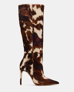 Knee-high stiletto boots with a brown and white cow print pattern