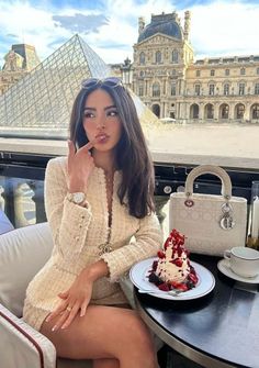 Woman in a tweed jacket with dessert at an outdoor cafe near the Louvre
