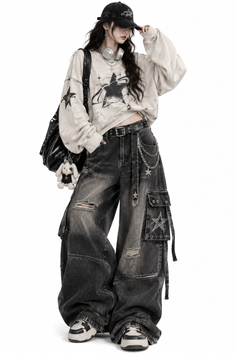 Person in a baseball cap, oversized sweatshirt, and ripped cargo jeans