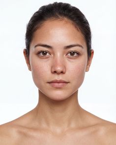 Woman with dark hair and bare shoulders against a white background