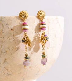 Pair of gold dangle earrings with seashell tops and colorful beads